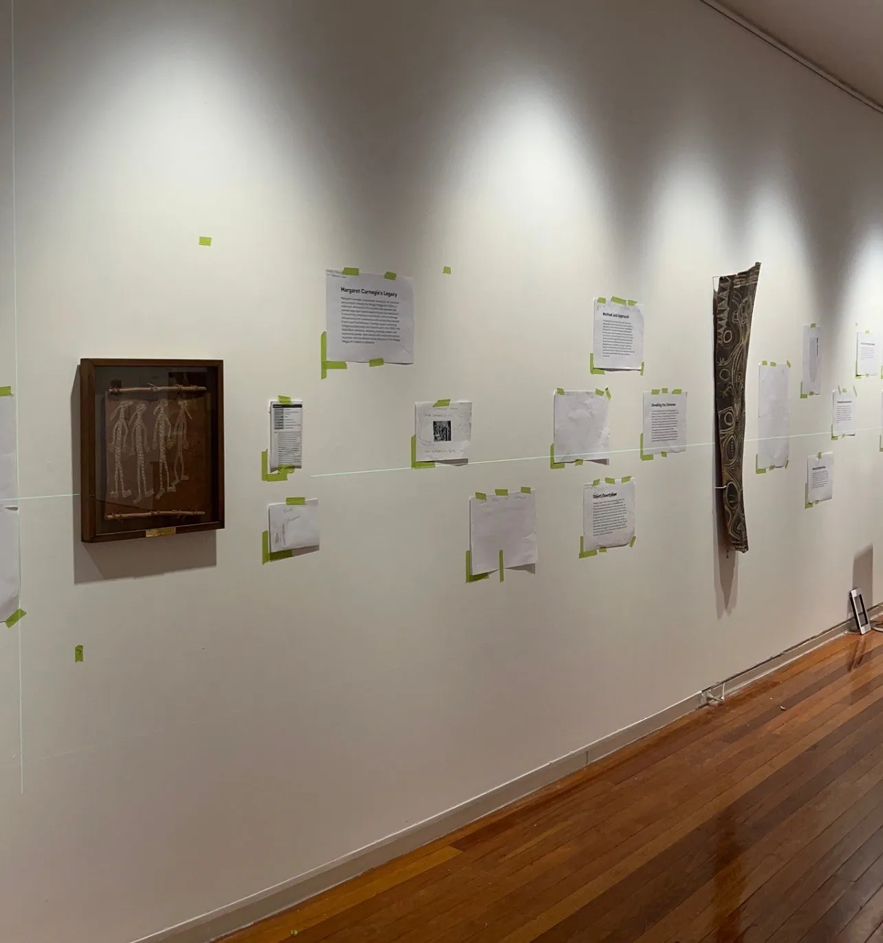The wall with the arrows and labels mocked up in coloured tape before the final graphics went up